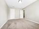 A tidy bedroom with neutral walls and two doors provides a blank canvas for personalization at 203 Canyon Lake Cir, Morrisville, NC 27560