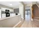 Open-concept kitchen with white cabinets and granite countertops that connects to the staircase and living room at 203 Canyon Lake Cir, Morrisville, NC 27560