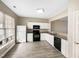 An eat-in kitchen features white cabinets, granite countertops, and stainless steel appliances at 203 Canyon Lake Cir, Morrisville, NC 27560