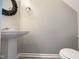 Cozy powder room showcasing a pedestal sink and decorative mirror at 203 Canyon Lake Cir, Morrisville, NC 27560