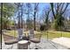 Backyard patio with Adirondack chairs and a woven outdoor seating set around a fire pit at 204 E Murray Ave, Durham, NC 27704