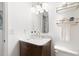Bathroom featuring a marble countertop vanity with gold fixtures, bright lighting, and matching gold shelving at 204 E Murray Ave, Durham, NC 27704