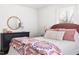 Bedroom features hardwood floors, a round mirror, a patterned bedspread, and bright natural light at 204 E Murray Ave, Durham, NC 27704