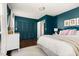 Comfortable bedroom with stylish decor, including dark blue walls and wood floors at 204 E Murray Ave, Durham, NC 27704