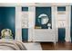 Charming bedroom featuring blue walls, white dresser, and natural light from the two windows at 204 E Murray Ave, Durham, NC 27704