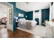 Bedroom with hardwood floors, teal walls, and bright natural light at 204 E Murray Ave, Durham, NC 27704