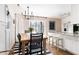 Bright dining room features a wood table, modern chandelier, and stylish black and white striped rug at 204 E Murray Ave, Durham, NC 27704