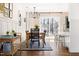 Cozy dining area with a modern chandelier, access to the backyard, and stylish striped rug at 204 E Murray Ave, Durham, NC 27704
