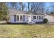 Charming single-story home with a freshly painted exterior, blue shutters, and a well-maintained front lawn at 204 E Murray Ave, Durham, NC 27704