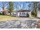 Inviting single-story home featuring a well-manicured lawn, gravel driveway, and freshly painted exterior at 204 E Murray Ave, Durham, NC 27704