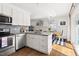The open concept kitchen features stainless steel appliances and flows into dining area at 204 E Murray Ave, Durham, NC 27704