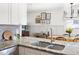 Kitchen view with granite countertops, stainless sink, and view into the dining room at 204 E Murray Ave, Durham, NC 27704