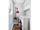 A well-lit laundry room includes a washer, dryer, cabinets and cleaning tools at 204 E Murray Ave, Durham, NC 27704