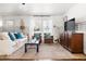 Bright living room is complete with hardwood floors, contemporary furnishings, and a relaxing ambiance at 204 E Murray Ave, Durham, NC 27704