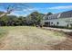 Expansive backyard featuring a lush lawn, mature trees, and a charming bench seating area at 206 S Salem St, Apex, NC 27502