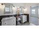 Modern bathroom features double sinks, updated fixtures and wainscoting with decorative shelving at 206 S Salem St, Apex, NC 27502