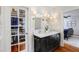 Bathroom with dual marble sinks, custom cabinets and drawers, and decorative lighting at 206 S Salem St, Apex, NC 27502