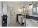 Bright bathroom featuring double sinks, updated fixtures and wainscoting with view to bedroom at 206 S Salem St, Apex, NC 27502