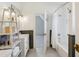 Bright bathroom features double sinks, updated fixtures, shower and wainscoting detail at 206 S Salem St, Apex, NC 27502