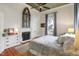 Bedroom featuring hardwood floors, large windows, and a decorative fireplace at 206 S Salem St, Apex, NC 27502