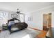 Bright bedroom featuring a unique metal bed frame, hardwood floors, and neutral paint at 206 S Salem St, Apex, NC 27502