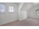 Bright bedroom features windows, neutral decor, white walls and carpeted flooring throughout at 206 S Salem St, Apex, NC 27502