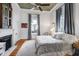 Bedroom with a decorative fireplace, a ceiling fan, and natural light at 206 S Salem St, Apex, NC 27502