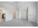 Bright bedroom featuring neutral decor, white walls and carpeted flooring throughout at 206 S Salem St, Apex, NC 27502