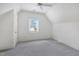 Bright bedroom with plush carpet, a ceiling fan, and large window at 206 S Salem St, Apex, NC 27502