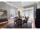 Elegant dining room boasts hardwood floors, bay window, and a striking chandelier at 206 S Salem St, Apex, NC 27502