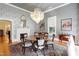 Chic dining room with a stunning chandelier, round table, patterned wallpaper, and elegant decor at 206 S Salem St, Apex, NC 27502