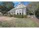 Lovely home exterior with a manicured lawn, mature trees, and a charming front porch at 206 S Salem St, Apex, NC 27502
