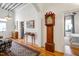 Grand foyer with high ceilings, hardwood floors, rug, and tall antique grandfather clock at 206 S Salem St, Apex, NC 27502