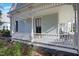 Exterior view showing the covered front porch with decorative railings and comfortable seating at 206 S Salem St, Apex, NC 27502