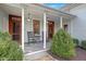 Charming front porch with rocking chairs and warm lighting, perfect for relaxing outdoors at 206 S Salem St, Apex, NC 27502
