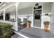 Inviting front porch with rocking chairs, grey flooring, and craftsman columns at 206 S Salem St, Apex, NC 27502