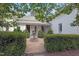 Inviting front yard with manicured hedges, a stone fountain, and a well-maintained gravel path at 206 S Salem St, Apex, NC 27502