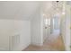 Bright hallway featuring neutral decor, white walls, carpeted flooring and closet space at 206 S Salem St, Apex, NC 27502