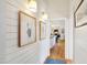 Hallway with beautiful artwork and light fixtures leading to the kitchen and living spaces at 206 S Salem St, Apex, NC 27502