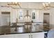 Bright kitchen featuring stainless steel appliances, a mosaic backsplash, and a dark marble center island at 206 S Salem St, Apex, NC 27502