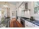 Elegant kitchen with dark marble counters, stainless steel appliances, and custom white cabinetry at 206 S Salem St, Apex, NC 27502