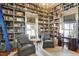 Grand library with floor-to-ceiling shelving, a rolling ladder, and a desk area at 206 S Salem St, Apex, NC 27502