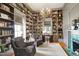 Cozy library with floor-to-ceiling bookshelves, a fireplace, and comfortable seating at 206 S Salem St, Apex, NC 27502