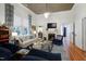Bright living room featuring a fireplace, bar area, hardwood floors and comfortable seating at 206 S Salem St, Apex, NC 27502