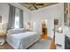 Spacious main bedroom with a decorative ceiling, light blue bedding, and bright natural light at 206 S Salem St, Apex, NC 27502