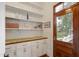 Pantry featuring custom white cabinets with a wood counter and an exterior door at 206 S Salem St, Apex, NC 27502