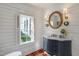 Charming powder room with ship lap walls, marble top vanity, and an ornate mirror at 206 S Salem St, Apex, NC 27502