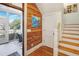 Stairway featuring wood accent wall leading to a screened-in porch and upper level at 206 S Salem St, Apex, NC 27502
