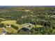 Expansive aerial view of a beautiful home, pond, and lush, green surroundings at 220 Epps Clark Rd, Siler City, NC 27344