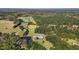 Aerial view of estate property with lush green landscape, ponds, mature trees, and winding driveway at 220 Epps Clark Rd, Siler City, NC 27344